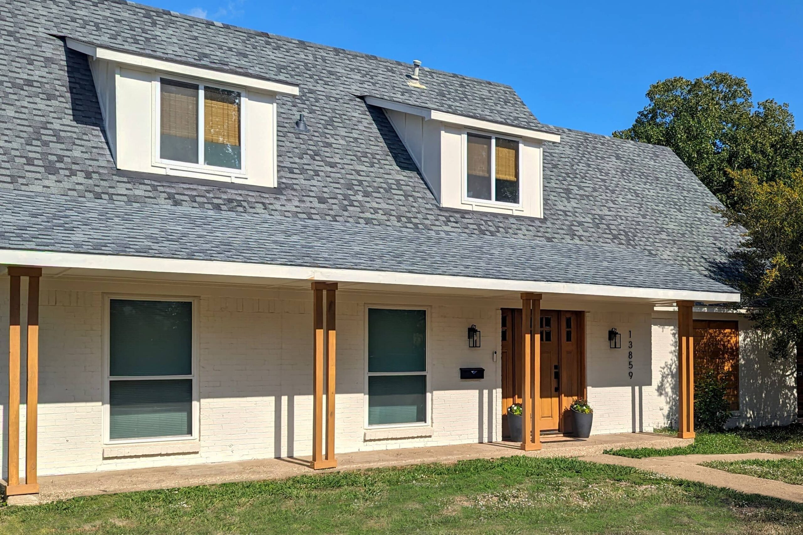 Exterior home remodel with porch and dormers added